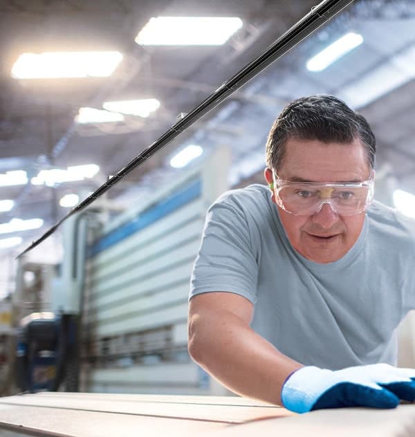 KÜBLER GmbH employee wearing safety goggles during the production of an NRV hall heating system