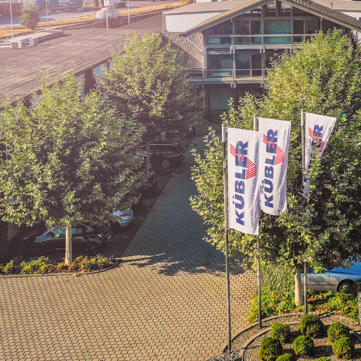 Aerial view of a modern company site with flags.