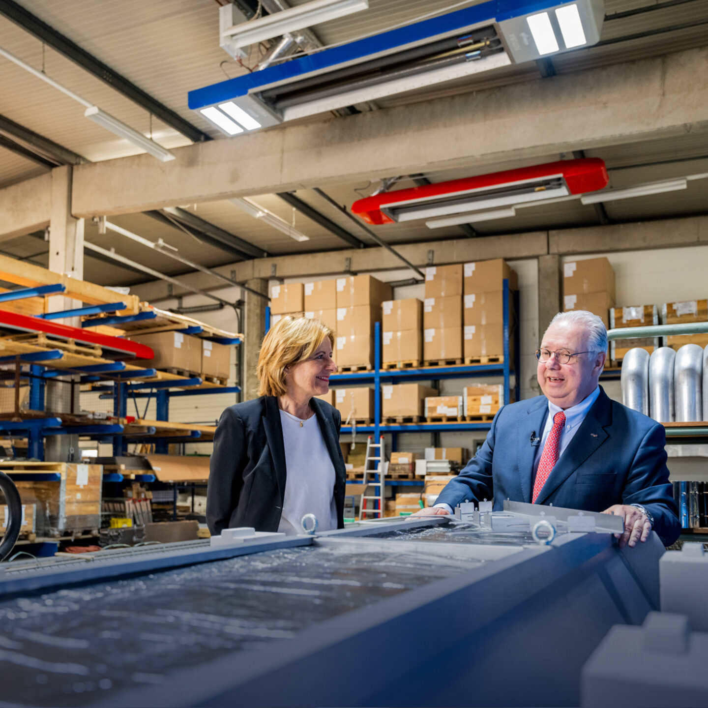 Business people discuss plans in a warehouse.