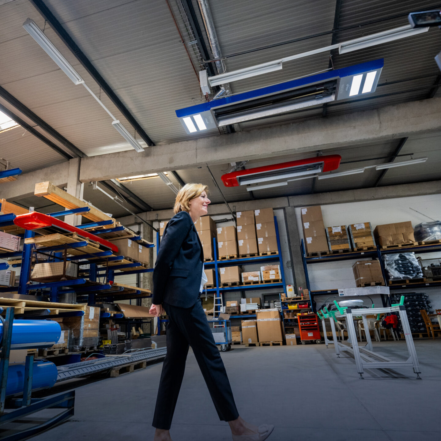 Woman walks in a warehouse.