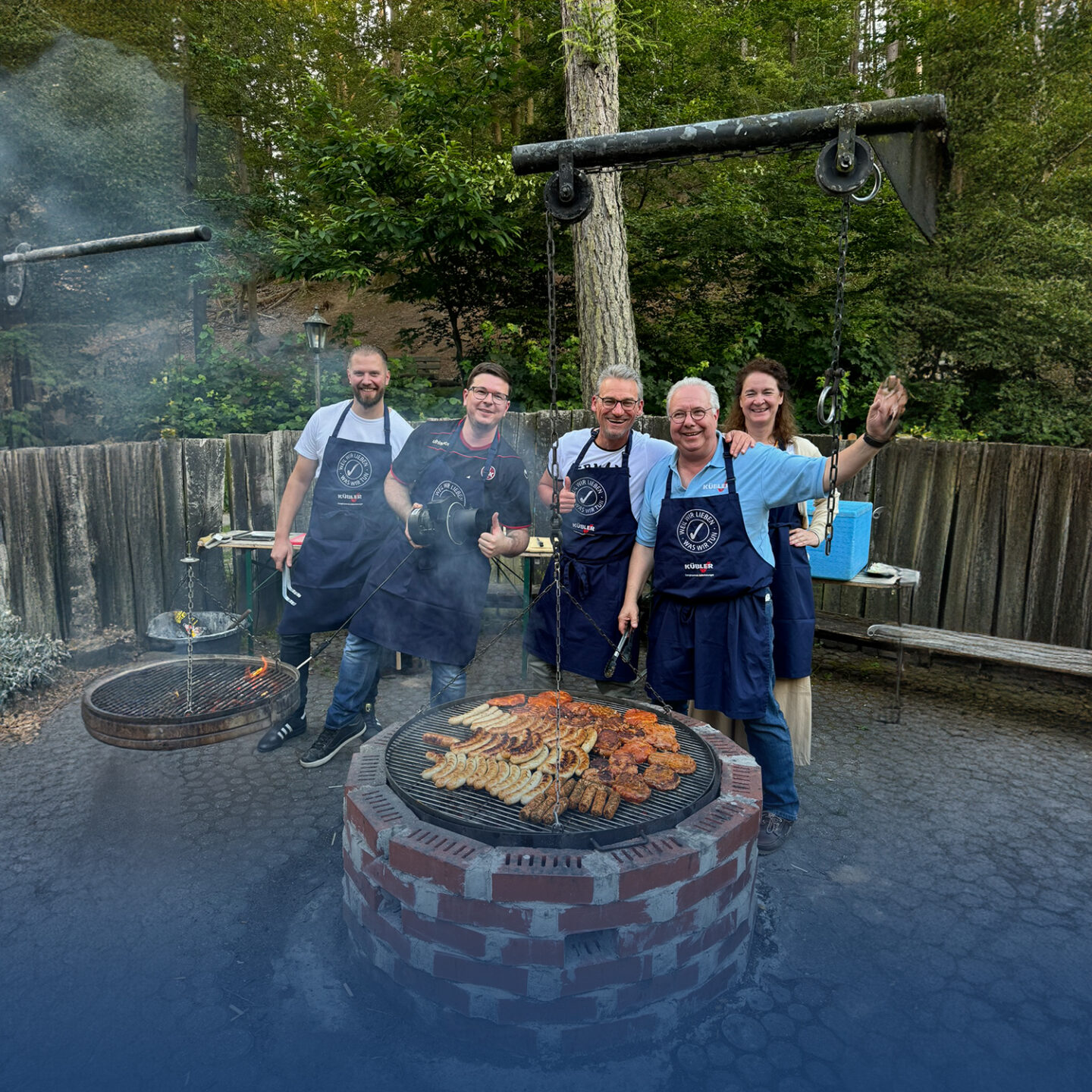 Friends barbecue together outdoors.