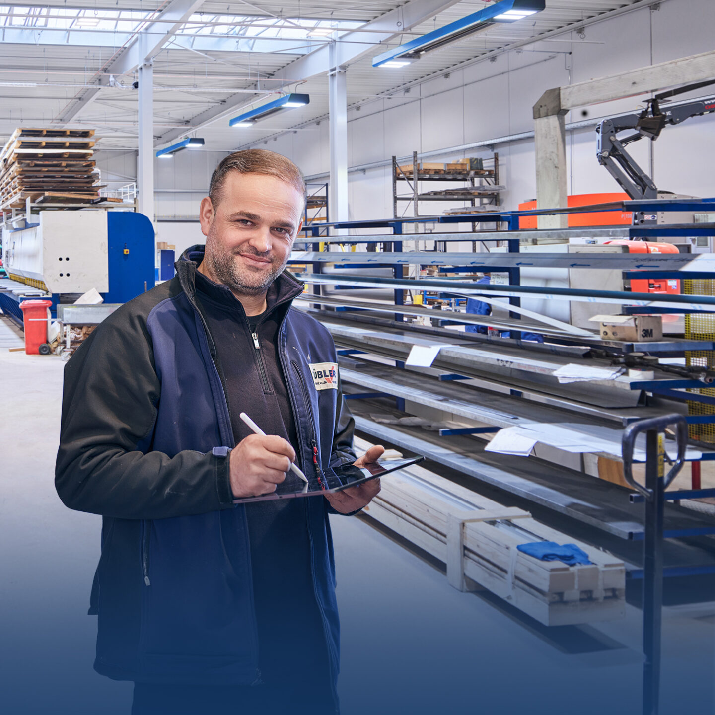 Man with tablet in industrial workshop