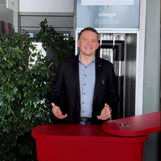 Smiling man standing at the red reception desk