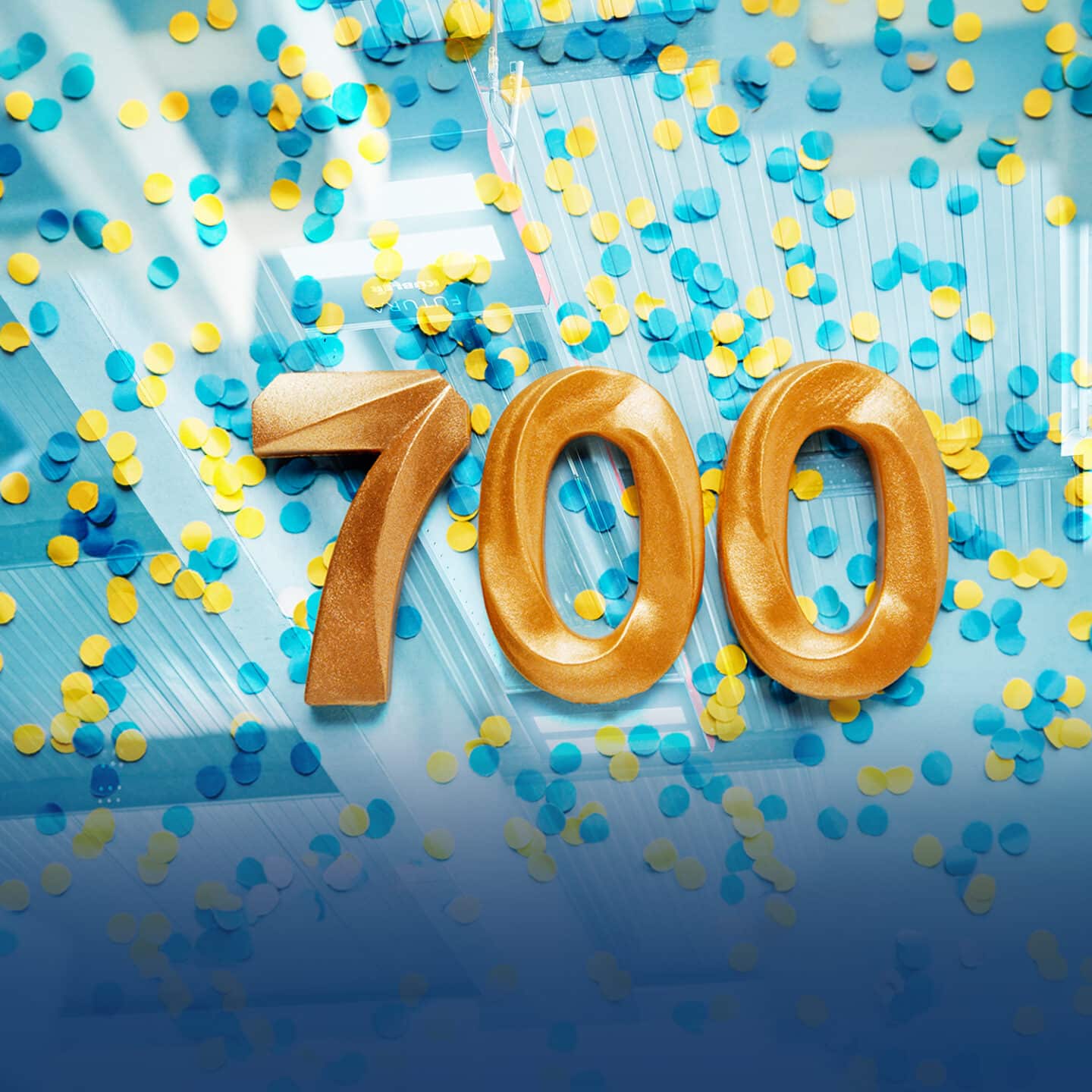 Golden number 700 surrounded by colorful confetti