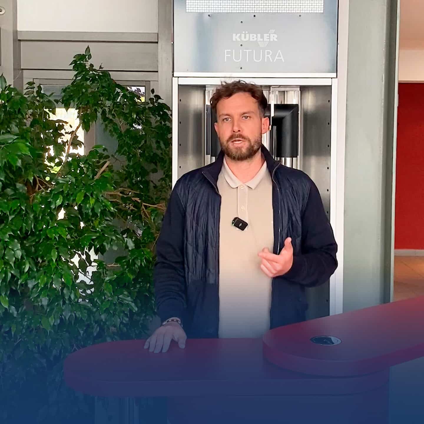 Man standing in front of an elevator next to a plant