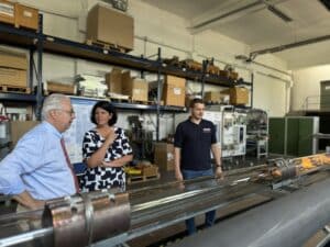 Three people discussing in a factory