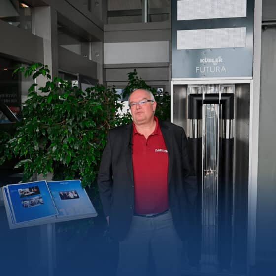 Man in front of modern Kübler Futura pendulum clock