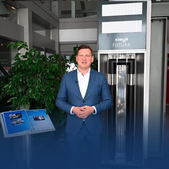 Man in blue suit in front of modern elevator