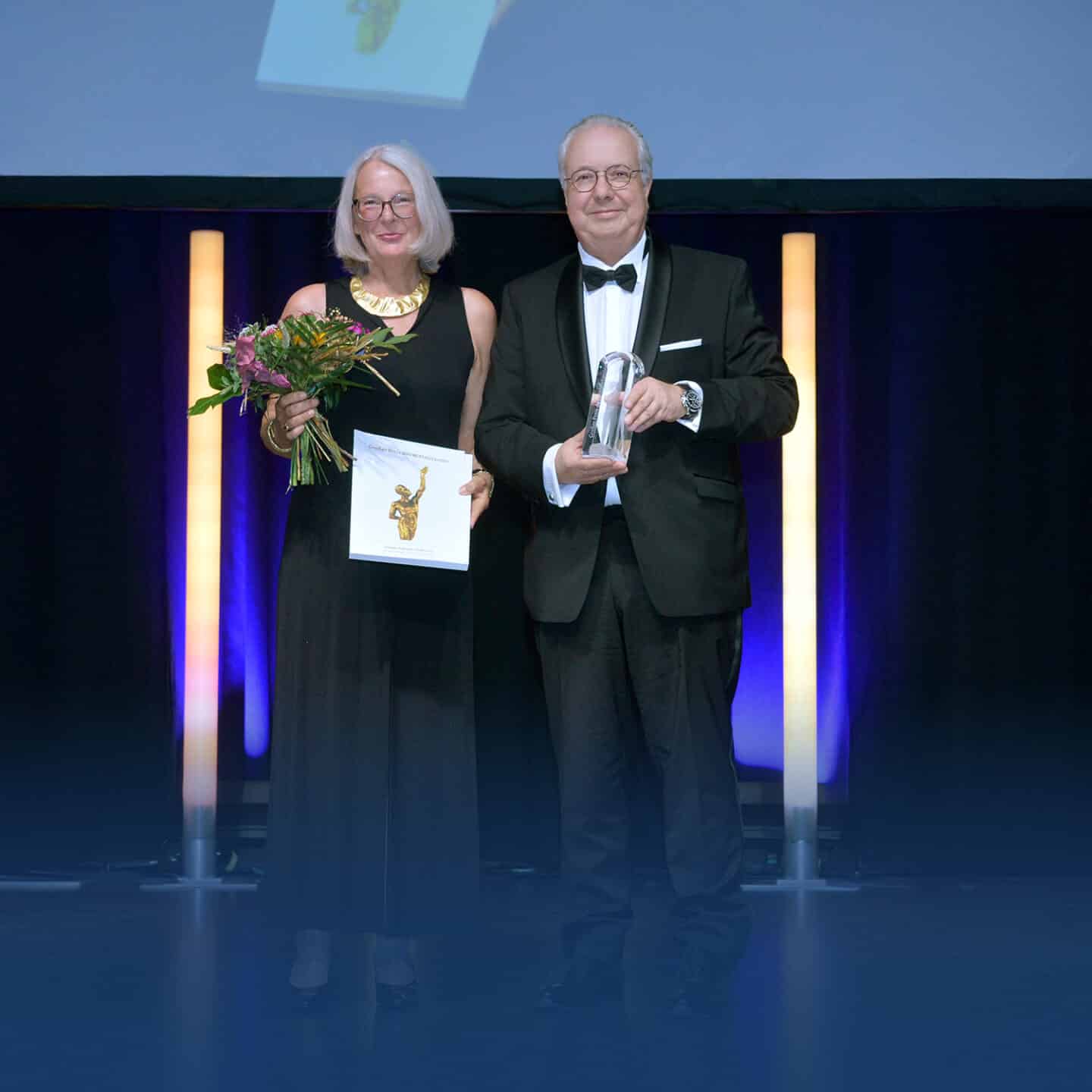 Couple receives prize on stage