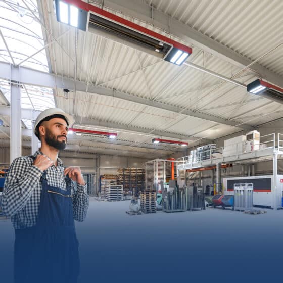 Worker in hard hat looks at factory floor