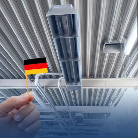 Hand holds German flag in industrial hall