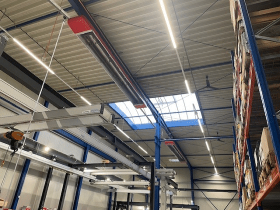 Illuminated warehouse with shelves and crane