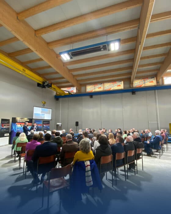 People at a conference in an industrial hall