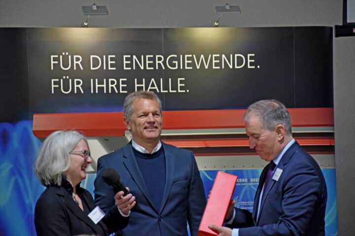 Three people talking at a trade fair