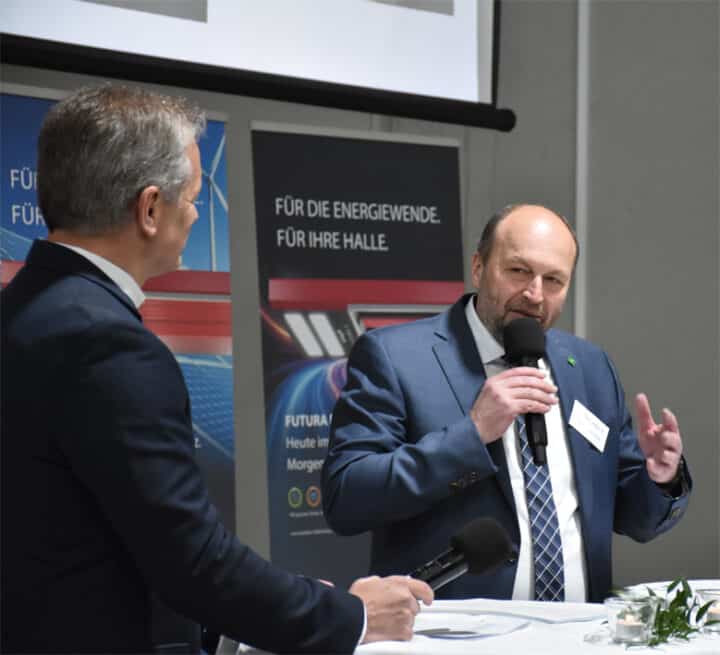 Two men discuss at a conference