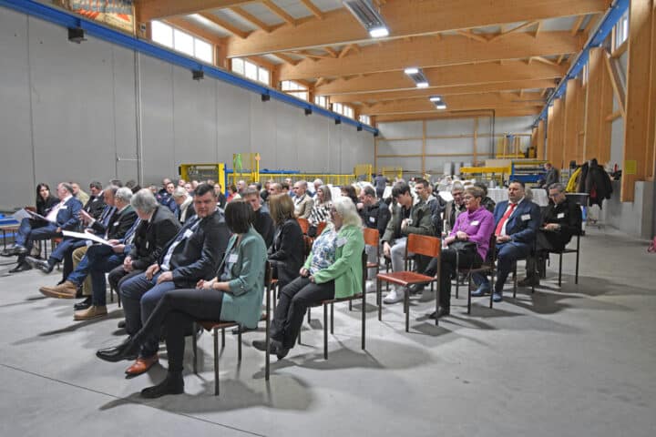 People at a meeting in an industrial hall